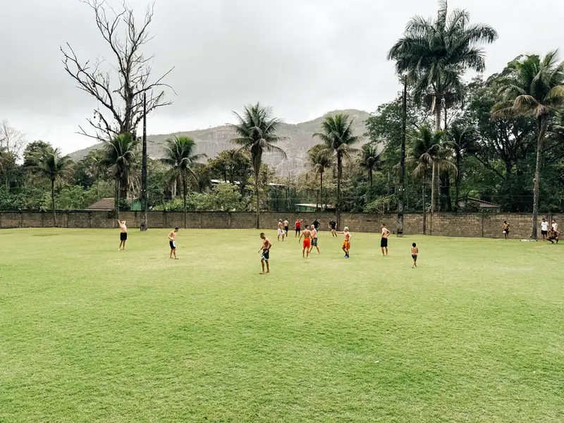 Campo de futebol gramado com montanhas ao fundo